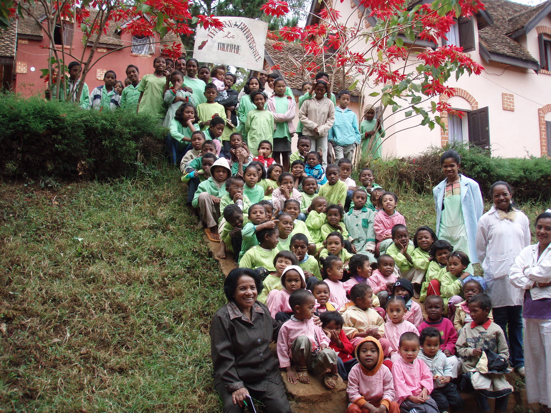 Full group photo of staff and children in Le Triomphe's Children's orphanage in Madagascar