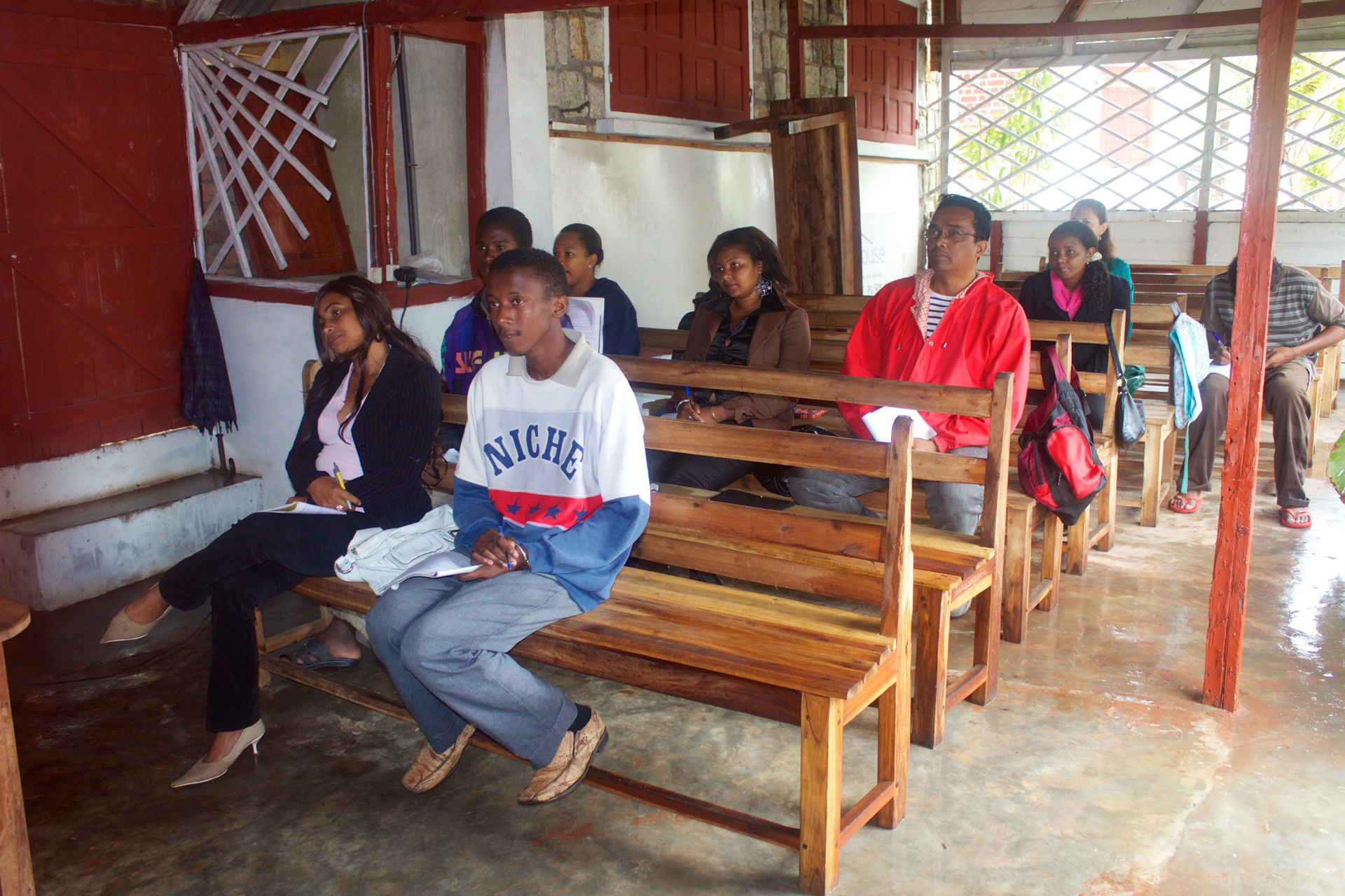 The Mission House hosting a classroom of students on wooden benches and chairs